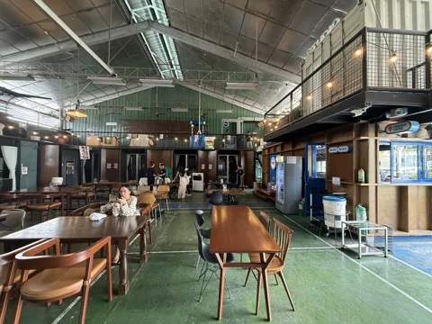 Tables and open gathering space beneath the Commons roof