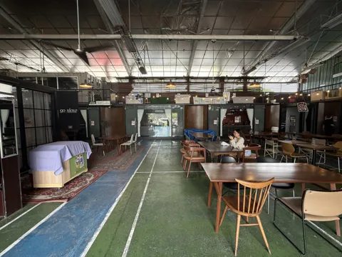 A view along the green central walkway and Commons tables
